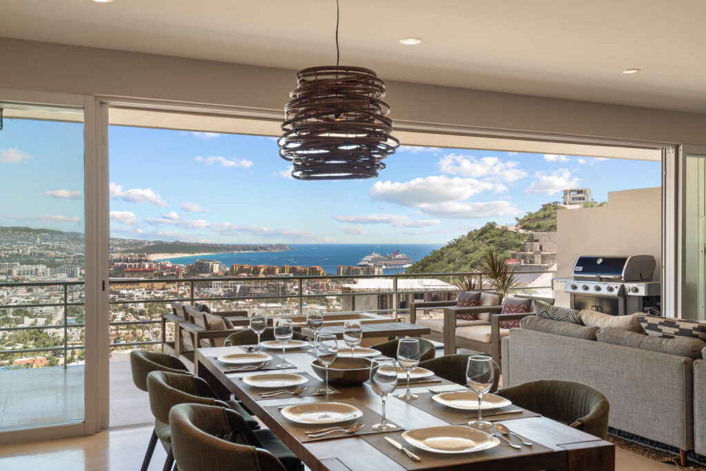 Los Cabos Morgan Residences Morgan Residences Condo 306 offers 67 m² of functional living space with one bedroom, one and a half baths, and a private balcony overlooking the city. The open floor plan connects the kitchen, dining, and living areas with marble-style tile throughout. The kitchen has granite counters, white cabinets, and an island with seating. The bedroom includes an ensuite bathroom with a walk-in shower and opens to the terrace. A separate half bath includes in-unit laundry. The building features a rooftop pool, gym, BBQ area, and – Cascadas Condo 722, Cabo San Lucas, Cabo San Lucas, BS