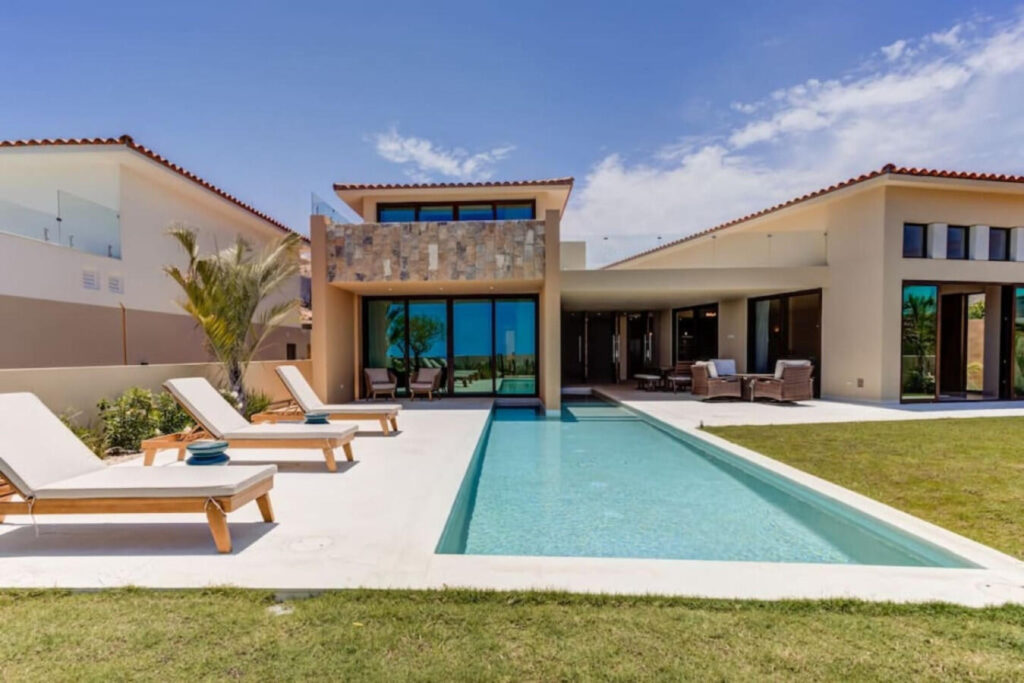 Los Cabos Pescadero Casa Soledad #3 Welcome to Pueblo Pescadero — where desert serenity meets ocean breeze and refined Baja living blends seamlessly with nature. This beautifully designed 3-bedroom, 2.5-bath residence offers the best of coastal comfort just minutes from Cerritos and San Pedrito beaches. Created by architect Hiram Arce, the home merges traditional Mexican craftsmanship with clean, modern lines—showcasing open living spaces filled with natural light and effortless indoor-outdoor flow. All bedrooms are conveniently located on the ground floor for cool, restful nights, while the upper level opens into an expansive great room and two large decks that extend the living space outdoors. The ocean-facing terrace captures panoramic Pacific – Lote 26 Vista Lago, San Jose del Cabo, BS