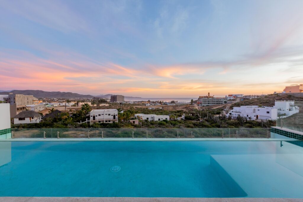 Los Cabos Morgan Residences Morgan Residences Condo 306 offers 67 m² of functional living space with one bedroom, one and a half baths, and a private balcony overlooking the city. The open floor plan connects the kitchen, dining, and living areas with marble-style tile throughout. The kitchen has granite counters, white cabinets, and an island with seating. The bedroom includes an ensuite bathroom with a walk-in shower and opens to the terrace. A separate half bath includes in-unit laundry. The building features a rooftop pool, gym, BBQ area, and – Phase 2, Cerritos Surf Residences, Pacific, Pacific, BS