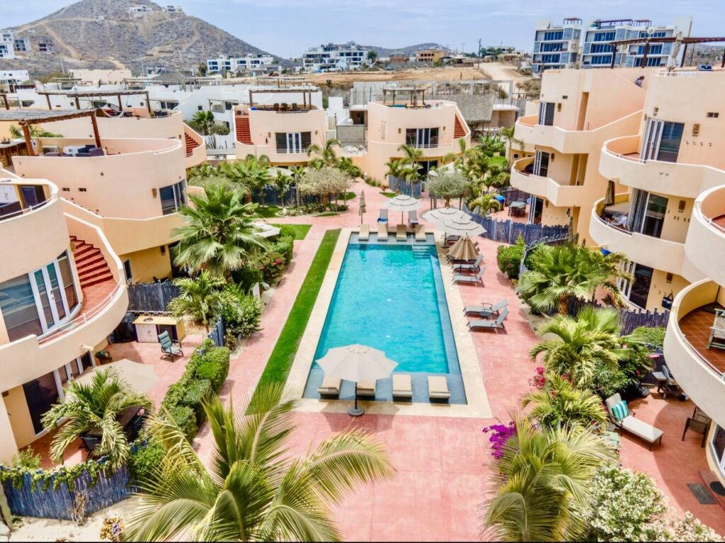 Los Cabos Morgan Residences Morgan Residences Condo 306 offers 67 m² of functional living space with one bedroom, one and a half baths, and a private balcony overlooking the city. The open floor plan connects the kitchen, dining, and living areas with marble-style tile throughout. The kitchen has granite counters, white cabinets, and an island with seating. The bedroom includes an ensuite bathroom with a walk-in shower and opens to the terrace. A separate half bath includes in-unit laundry. The building features a rooftop pool, gym, BBQ area, and – Sunrise,Cerritos Beach, Pacific, BS